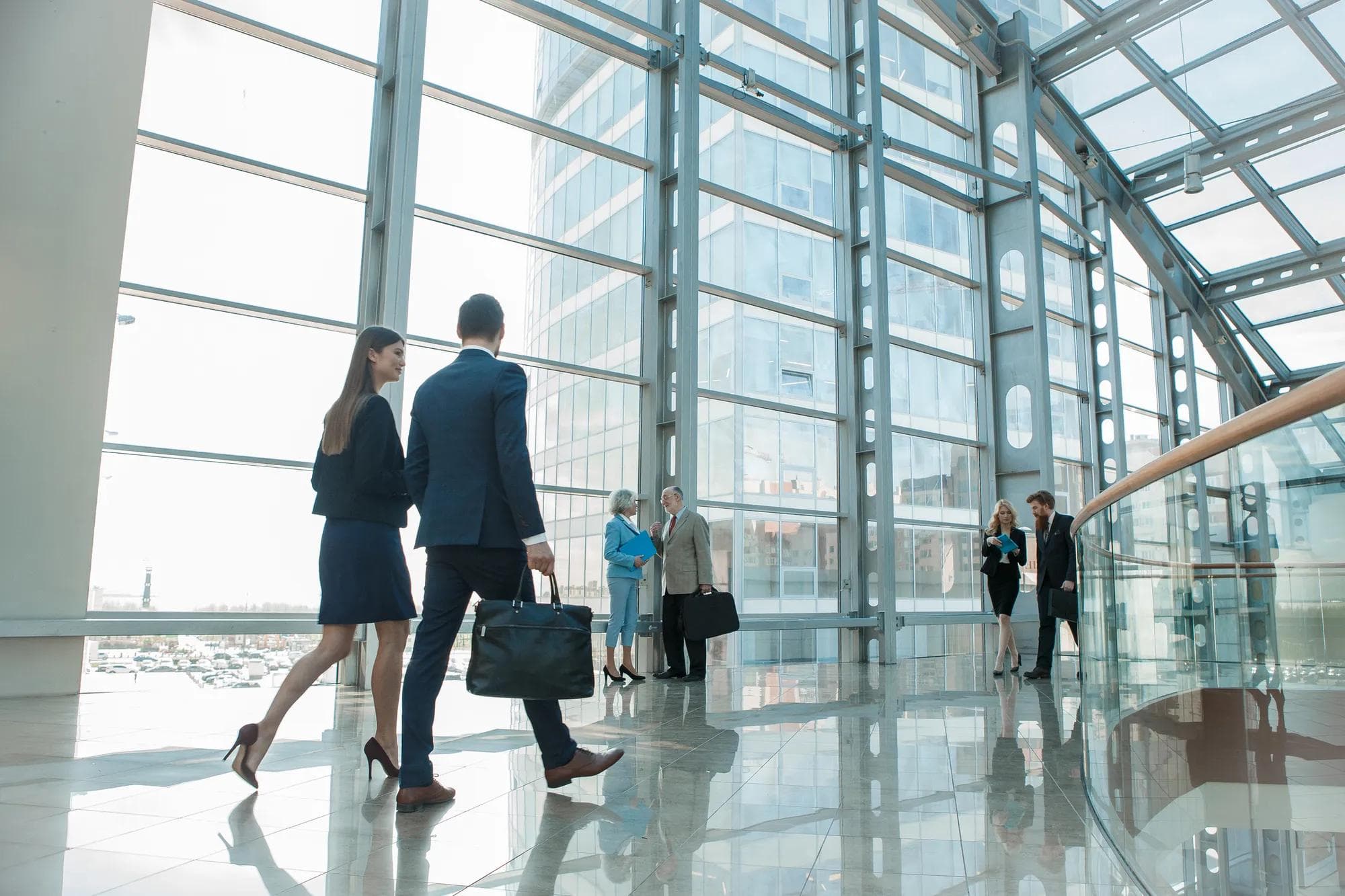 Business people walking inside of a glass building