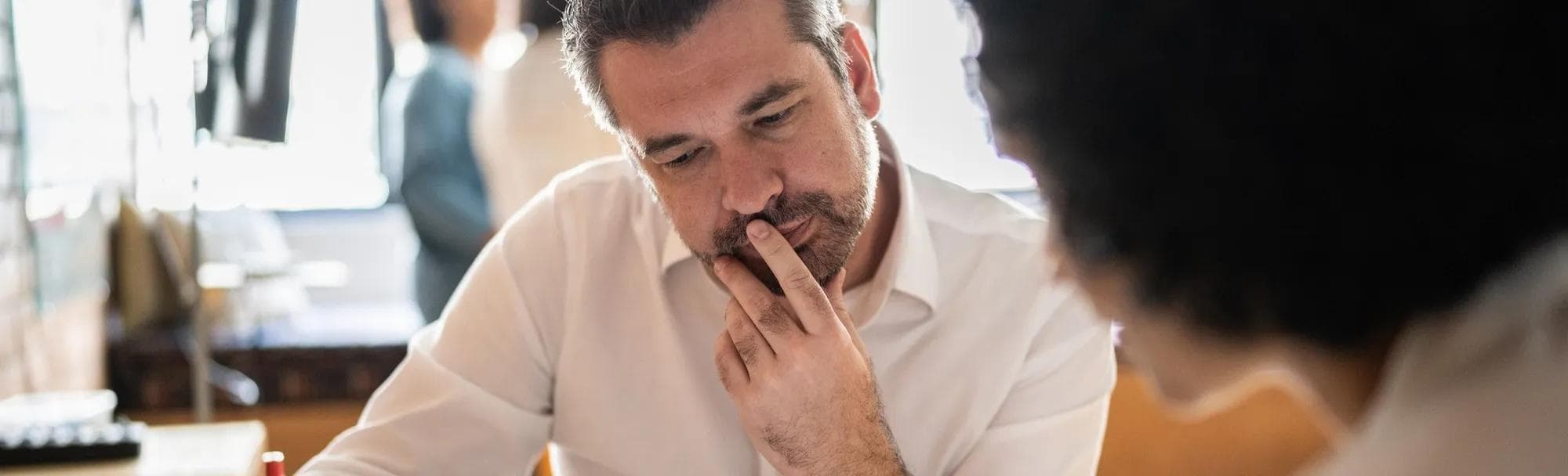 People in an office collaborate on solving a challenge.  