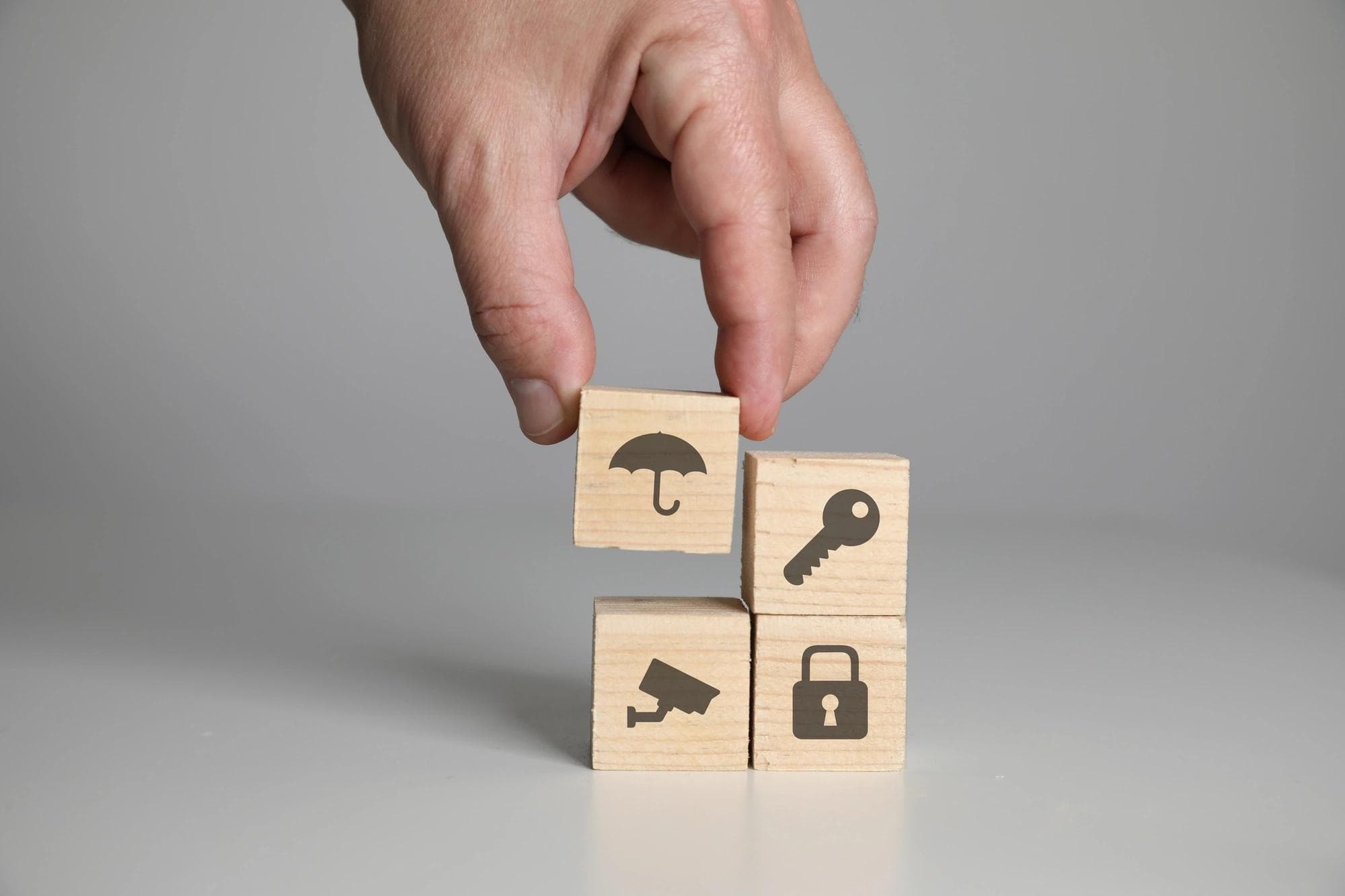 Wooden blocks with various icons are stacked to represent a fraud controls testing process.