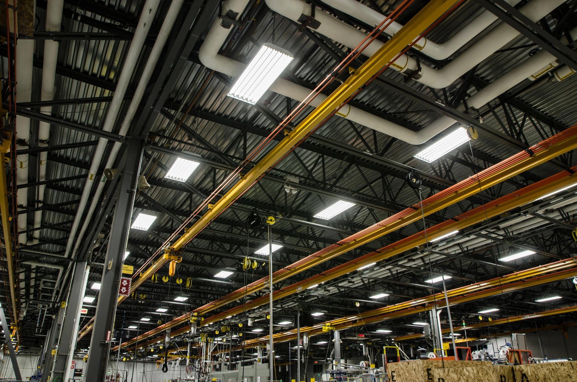 An upward looking perspective of the ceiling of a manufacturing plant with energy-efficient LED lighting installed.  