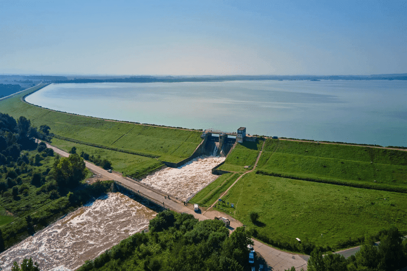 Aerial view of water dam releasing floodwater from reservoir
