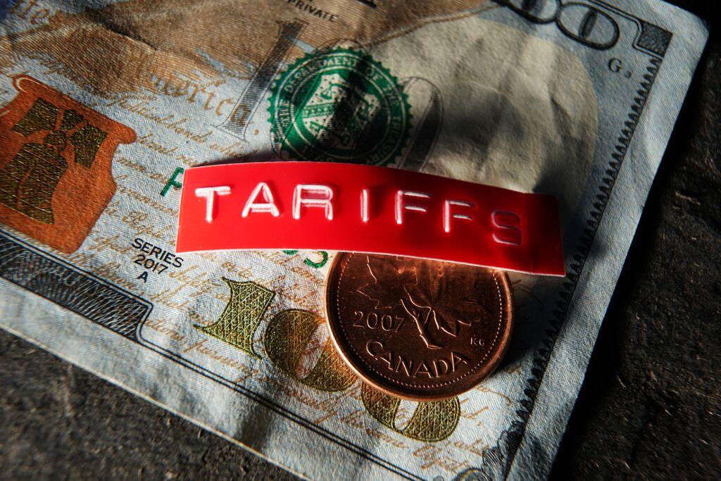 Canadian coin with tariff label on dollar bill