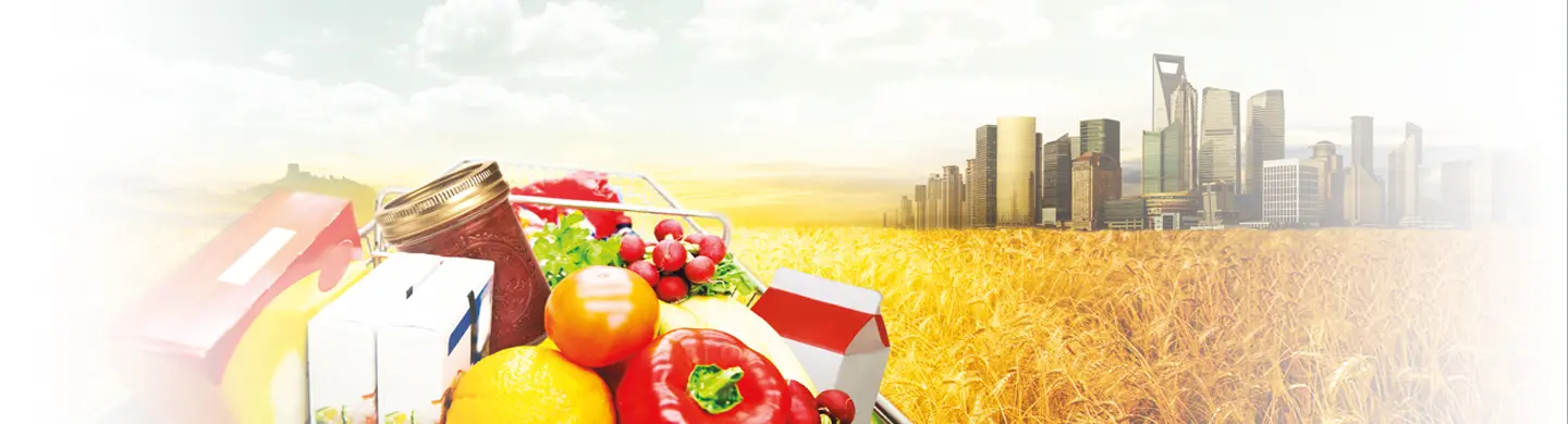 Shopping cart in a wheat field headed towards an urban center