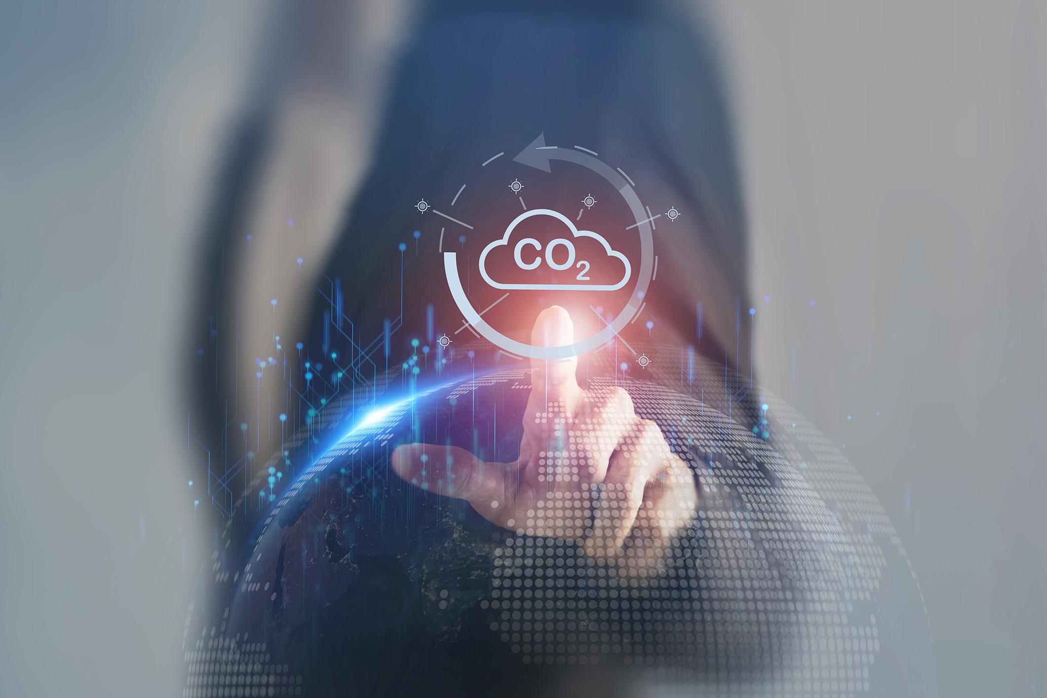 man in suit pointing to icon of CO2