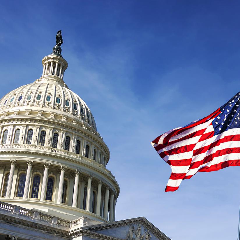 American flag waving with the Capitol Hill