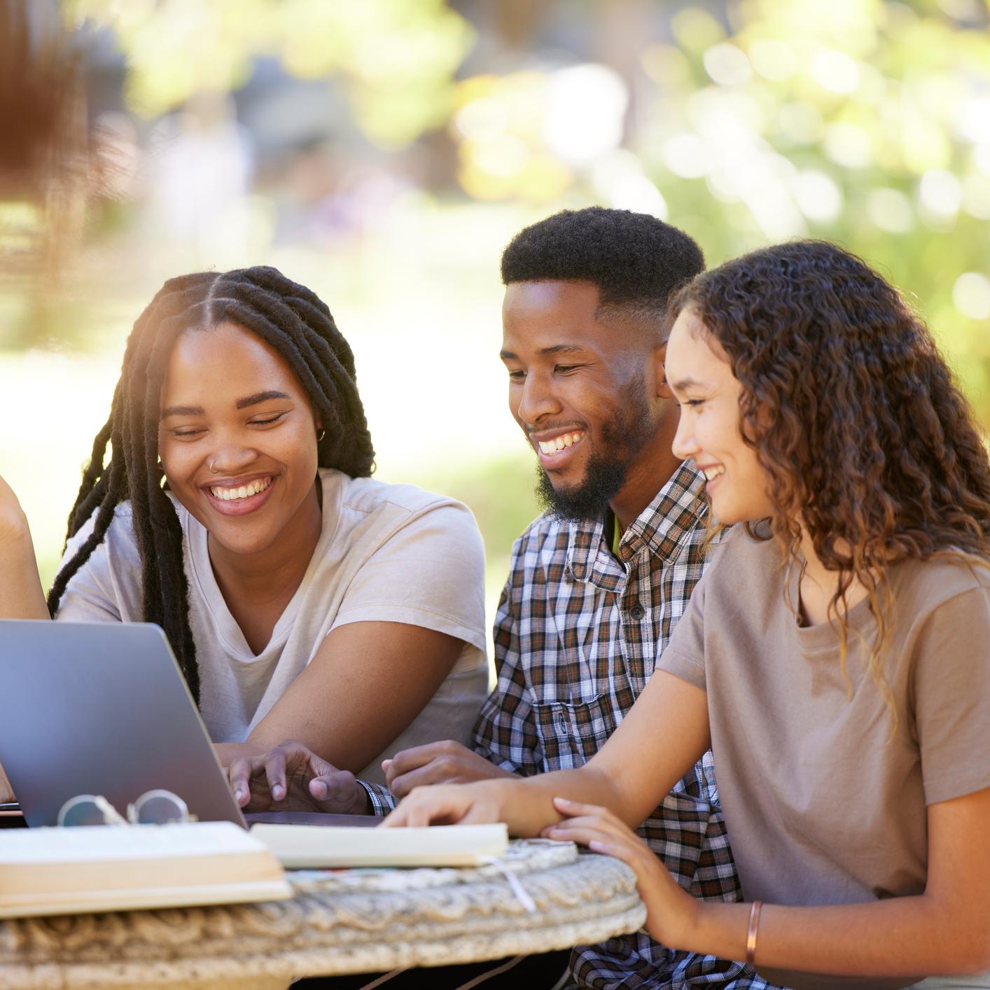 Students smiling with computer