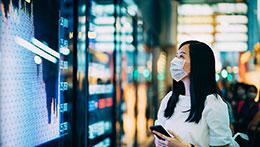 Woman watching market screens